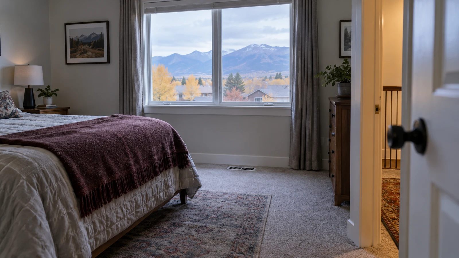 Colorado bedroom with a clear floor supply register, closed window, and open doorway to the hallway